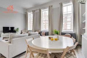 uma sala de estar branca com uma mesa e cadeiras brancas em Large Deluxe City Centre Apartment - Goergian Townhouse- Rodney St em Liverpool