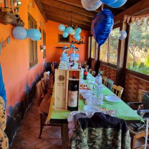 a dining room with a table with a bottle of wine at Stella Sulcitana in Gonnesa