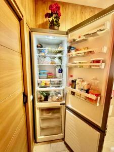 a refrigerator with its door open with food inside at Hostel Best Stay in Madrid