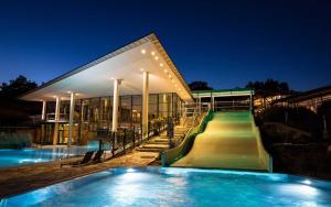 a building with a staircase in front of a swimming pool at Panoramabungalow _50_ im Feriendor in Truppach