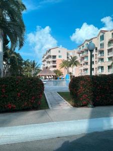 a view of a resort with palm trees and bushes at 4 BR apartment, 8 guests in Cancún
