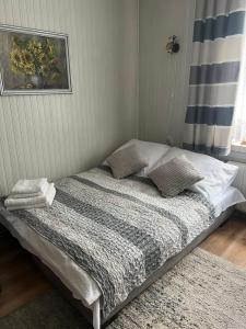 a bed sitting in a room with a window at Apartament Relax in Stronie Śląskie