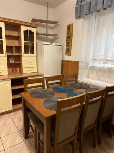 a kitchen with a table with chairs and a refrigerator at Apartament Relax in Stronie Śląskie