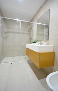 a bathroom with a tub and a sink and a shower at Tu oasis con piscina en Portonovo Sanxenxo in Sanxenxo