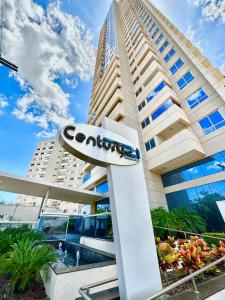 a building with a sign in front of it at PALMAS EXPERIENCE - FLAT ACONCHEGANTE no centro in Palmas