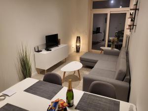 a living room with a couch and a tv at Huis ALNA 3 in Mechelen