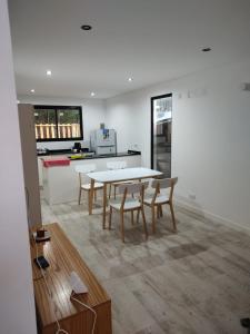 a kitchen and dining room with a table and chairs at Duplex Pinamar norte frente al bosque in Pinamar