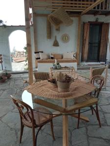 een tafel en stoelen op een patio met een bank bij Villa Haris in Sarti