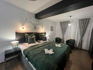 a bedroom with a large bed with two white flowers on it at Prorok Agroturystyka in Tereszpol
