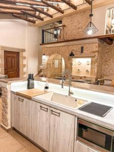 a kitchen with a sink and a counter top at Villa Recluso-3 bd luxury country villa, huge pool with hydromassage, individual bbq & large yard, mountain view in Maláxa