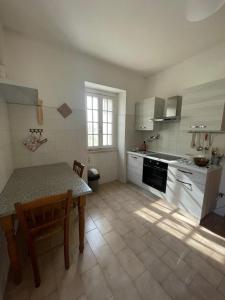 a kitchen with a table and a dining room at il casale di Bruno e Pina in Pantana +33 photos