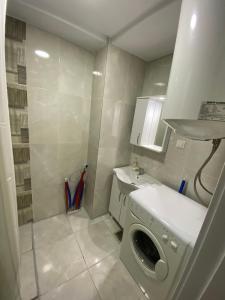 a laundry room with a washing machine and a sink at srle home in Skopje +11 photos