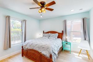 a bedroom with a bed and a ceiling fan at Casa Capel in Port Orange