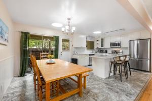 a kitchen with a wooden table and chairs at Westside Beauty in Santa Cruz