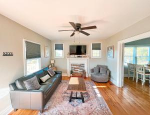 a living room with a couch and a ceiling fan at Cozy and Renovated 3 Bedroom Home 