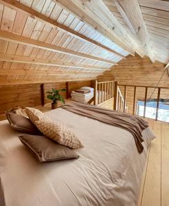 a large bed in a room with a wooden ceiling at Mountain Eco Shelter 5 in Funchal