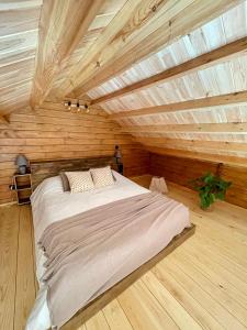a bedroom with a large bed in a wooden ceiling at Mountain Eco Shelter 5 in Funchal