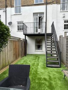 a house with a yard with a spiral staircase at Idyllic Islington Flat in London