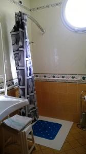 a bathroom with a shower curtain and a sink at Hotel Jean Marie in Arma di Taggia