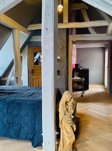 an attic room with a bed and a table at Vintner Suites in Neustadt an der Weinstraße