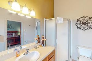 a bathroom with a sink and a shower and a mirror at Lorees Riverview in Florence