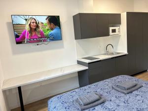 a kitchen with a tv hanging on the wall at Park Maksimir Apartments in Zagreb