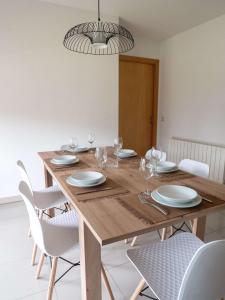 a dining room with a wooden table and chairs at Mestre Tornabell 11 in Bas