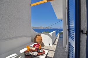 a room with a view of the ocean from a balcony at Panorama Hotel in Klima