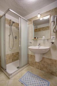 a bathroom with a shower and a sink at Hotel Cecchin in Aosta