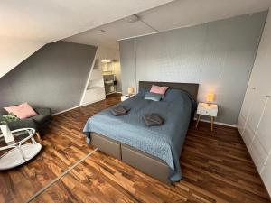 a bedroom with a bed and a couch in it at Apartments Marienburg in Nordstemmen