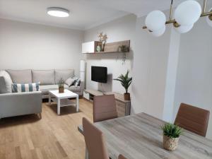 a living room with a couch and a table at Apartamento Sanlucar-El Pradillo in Sanlúcar de Barrameda