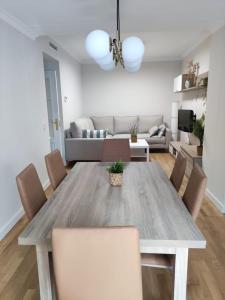a living room with a wooden table and chairs at Apartamento Sanlucar-El Pradillo in Sanlúcar de Barrameda