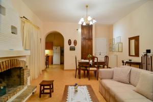 a living room with a couch and a fireplace at The Antique House in Batsi