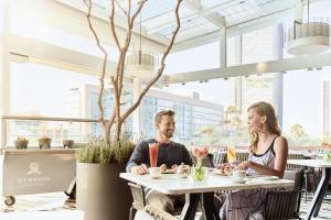 a man and woman sitting at a table in a restaurant at The St. Regis Mexico City in Mexico City