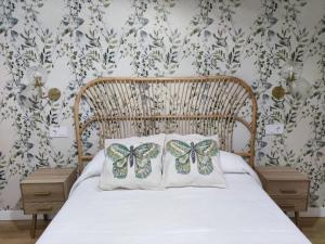 two butterflies on pillows on a bed in a bedroom at Apartamento Sanlucar-El Pradillo in Sanlúcar de Barrameda +7 photos