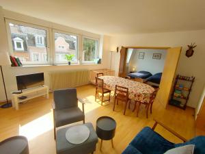 a living room with a table and a dining room at Calme Lumineux Spacieux Accueillant in Mulhouse