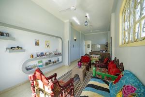 a living room with a couch and chairs and a window at Noby Guest House in Luxor