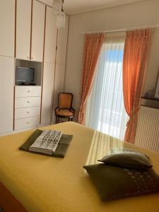 a bedroom with a bed with a keyboard and a window at Country house Nafpaktos in Nafpaktos