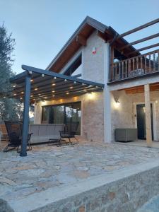 a pavilion with benches and tables on a patio at Villa Butterfly Valdanos in Ulcinj