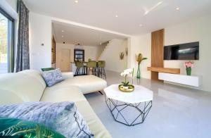 a living room with two white couches and a table at Apartment Rosa in Malinska