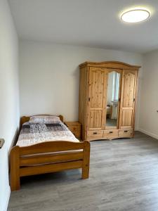 a bedroom with a bed and a dresser and a mirror at Oberhausen Apartments in Oberhausen