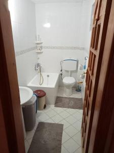 a bathroom with a tub and a toilet and a sink at Detached stone house with access to a large garden near beach in Kemer