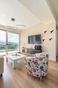 a living room with a couch and a table at Gk Halepa Luxury apartment in Chania Town