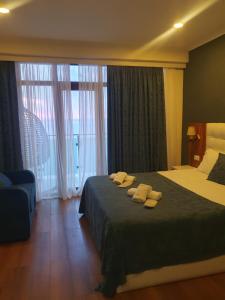 a hotel room with a bed with two towels on it at The Fresh Wave hotel in Batumi