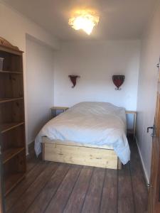 Schlafzimmer mit einem Bett und Holzboden in der Unterkunft Une terrasse à L’Estaque + stationnement in Marseille
