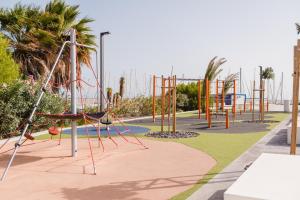 a playground with a swing set in a park at Precioso apartamento in San Miguel de Abona
