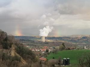 a smoke stack with a rainbow in the background at Wohnung 53m2 gross mit Internet TV Küche Mit schöner Aussicht 53 m2 in zwischen Olten und Aarau in Lostorf