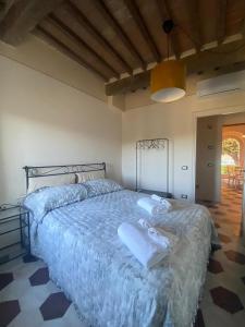 a bedroom with a large bed with towels on it at punti di vista in Bibbona