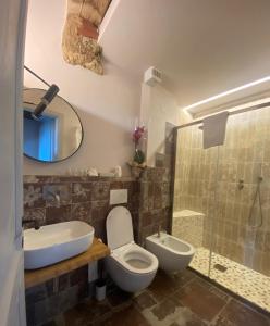 a bathroom with a toilet and a sink and a shower at punti di vista in Bibbona