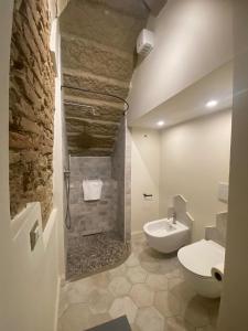 a bathroom with a white toilet and a sink at punti di vista in Bibbona